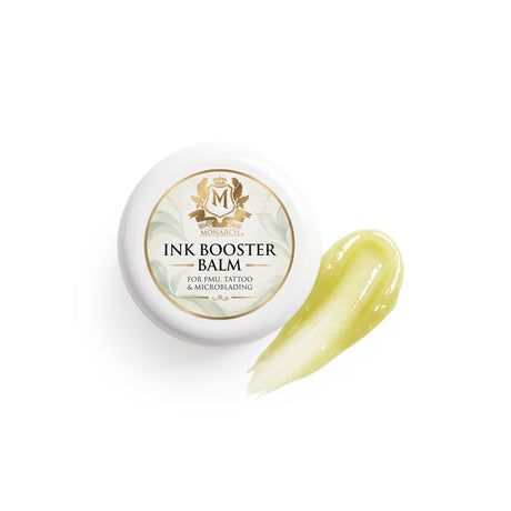 Skin Monarch Ink Booster Balm 30ml, vāciņš blakus spīdīga dzeltena balzama uztriepumam